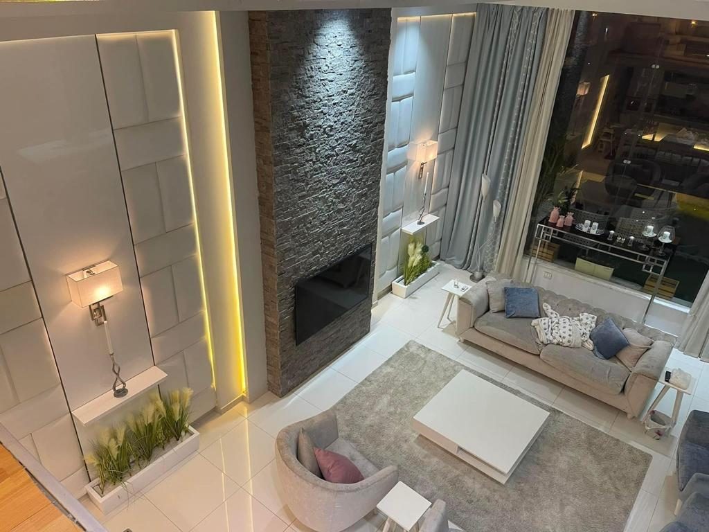 Bright Interiors finishing work: living room stone wall